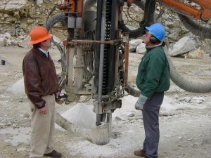 Tom Donovan of Capitol Construction (left) with a temperature gauge and Gary Davidson (right) of Yankee. Tom Donovan confirms that, “the temperature of the new steel’s couplings averaged under 200º F. This lower temperature is due almost entirely to the greater straightness of holes drilled with the Sandvik60 steel.”