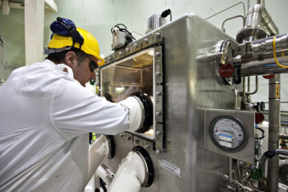 Operator taking NaK sample for transfer to Labs