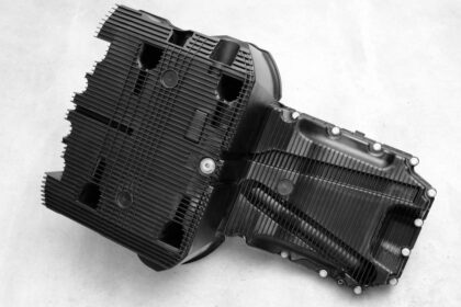 New truck oil pan made of DuPont Zytel polyamide resin, injection moulded by ElringKlinger for Mercedes-Benz 4 and 6-cylinder diesel engines, is up to 50 percent lighter than aluminium, resists stone and gravel chip impact, is quieter at around 2dB, and integrates functions not possible with metal. Image: DuPont/ElringKlinger