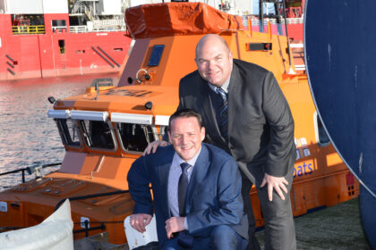 Gavin Esslemont, Director of Aberdeen-based event organisers Xcite Media Ltd and commercial consultancy Xcite Oil and Gas, and Darren Ross (front) Fellow Director of Xcite Media Ltd by an RNLI vessel in Aberdeen