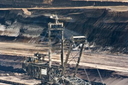 silver-steel-mining-crane-on-black-rocky-soil-during-daytime-60008