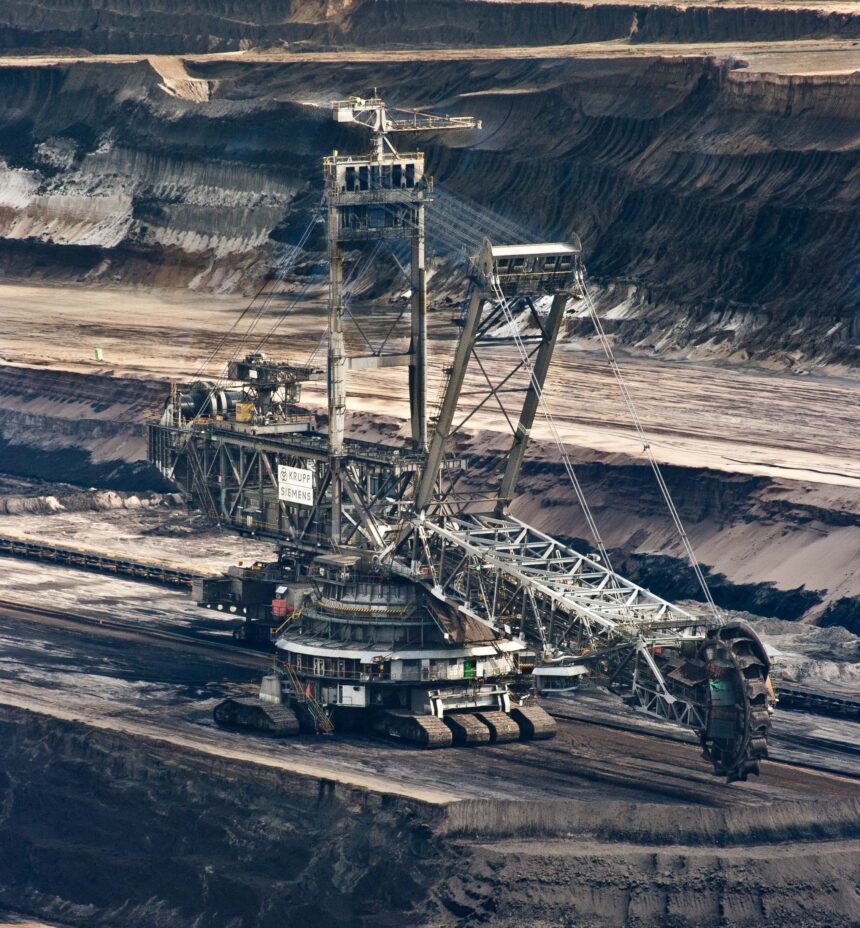 silver-steel-mining-crane-on-black-rocky-soil-during-daytime-60008