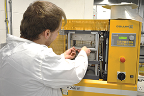 Teesside University student using a hot platen press to manufacture thermoplastic composites