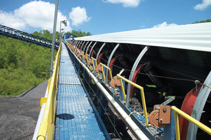Hinged drip pans designed to be lowered with winches